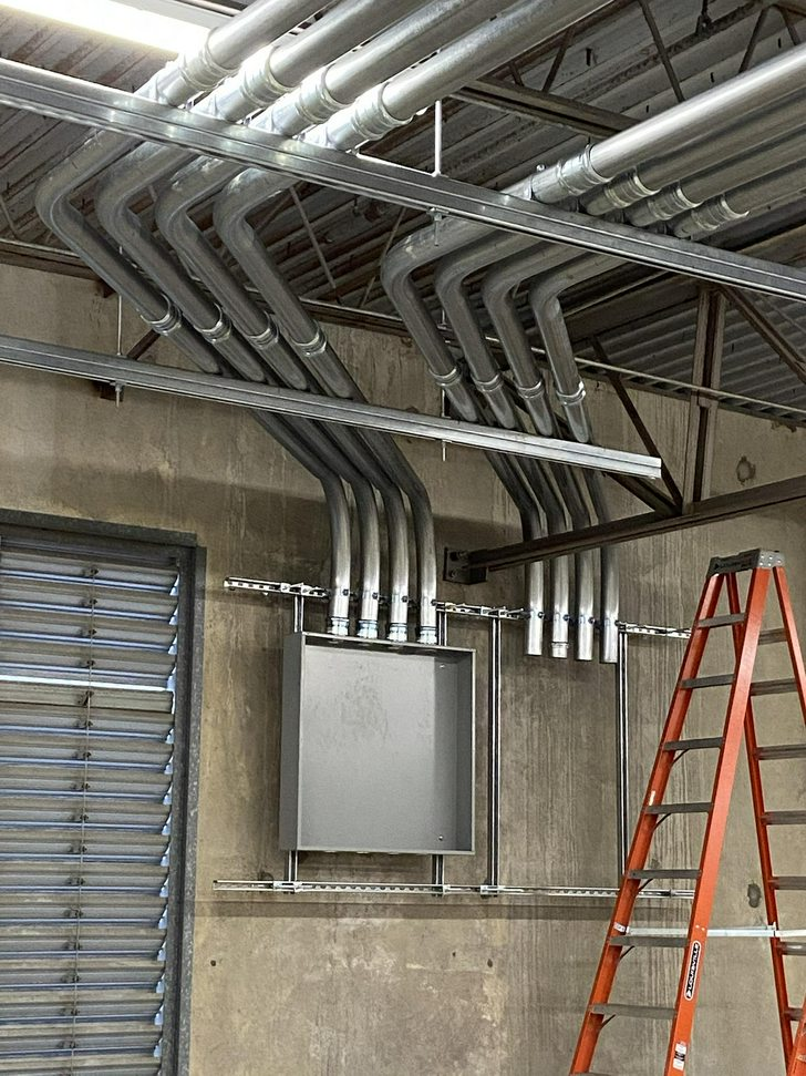 Clean EMT conduit runs aligned and strapped in
commercial space
